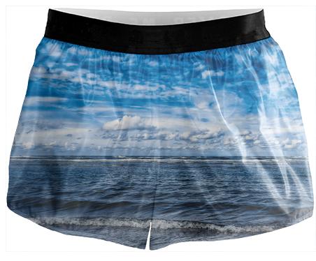 Cloudy day on the beach Running Shorts