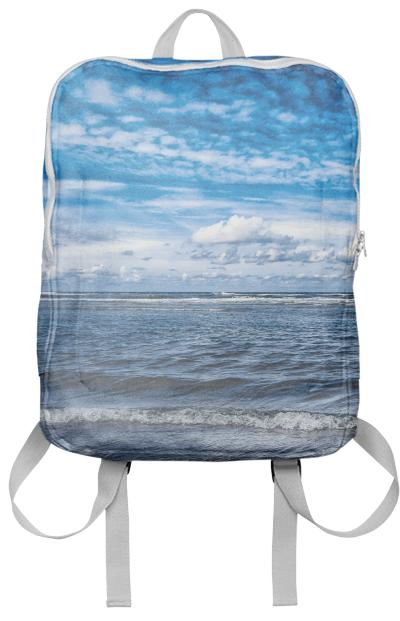 Cloudy day on the beach Backpack