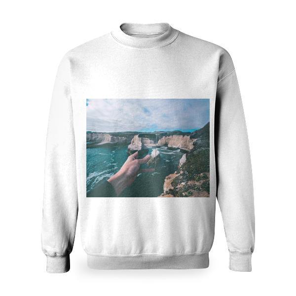 Person Holding Smartphone Capturing Pictures Of Body Water Beside Rock Formations Under Cloudy Sky During Daytime Basic Sweatshirt