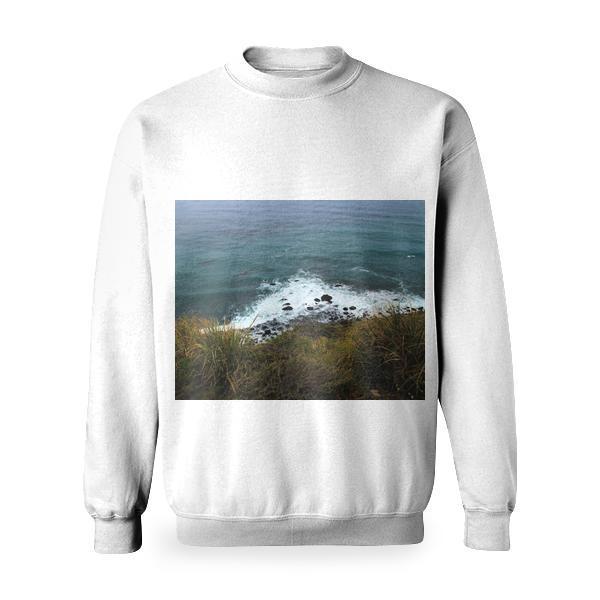 White Froth Waves Of Teal Water Against Green Grass Shore Basic Sweatshirt