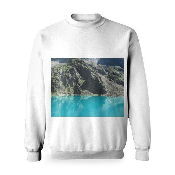 Teal Calm Body Of Water Beside Rock Mountain During Day Time Basic Sweatshirt