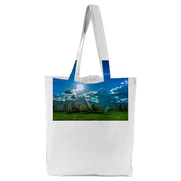 Trees And Grass Field Under Cloudy Sky During Daytime Tote Bag