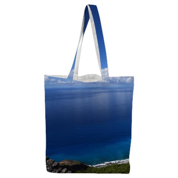Blue Calm Sea Near High Rise Mountain Under Blue Sky During Daytime Tote Bag