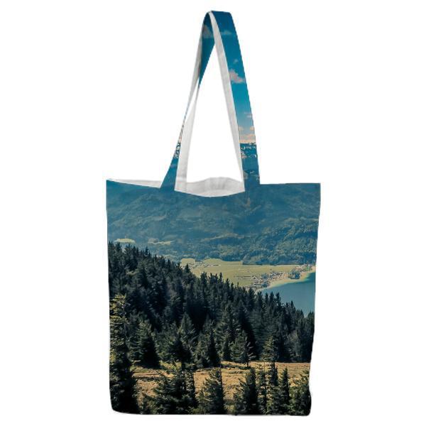 Green Pine Trees Near Lake Under White Clouds And Blue Sky During Daytime Tote Bag