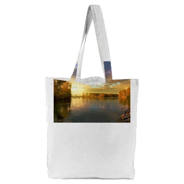 Trees Near Body Of Water Under Dark Sky During Daytime Tote Bag