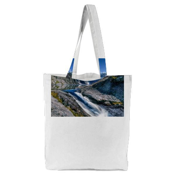 Waterfall In Between Of Gray Rocky Mountain During Daytime Tote Bag