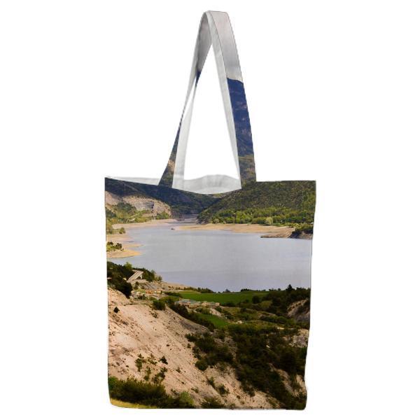 Large Body Of Water Surrounded By Green Mountains During Daytime Tote Bag