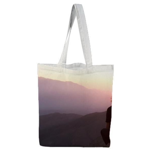 4 People Sitting On Rocks Hill Against Setting Sun Tote Bag