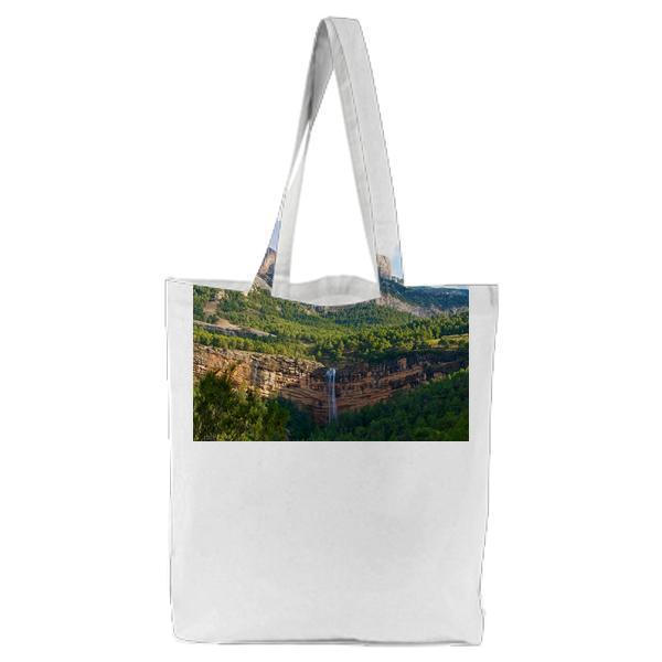 Waterfalls On Brown Cliff Near Green Trees At Daytime Tote Bag