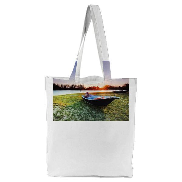 Boat On Body Of Water During Sunset Tote Bag