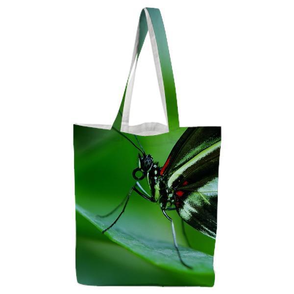 Black And White Butterfly On Green Leaf During Daytime Tote Bag