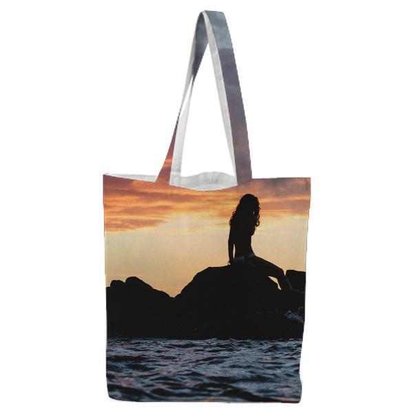 Silhouette Of Woman Siting On Rock During Sunset Tote Bag