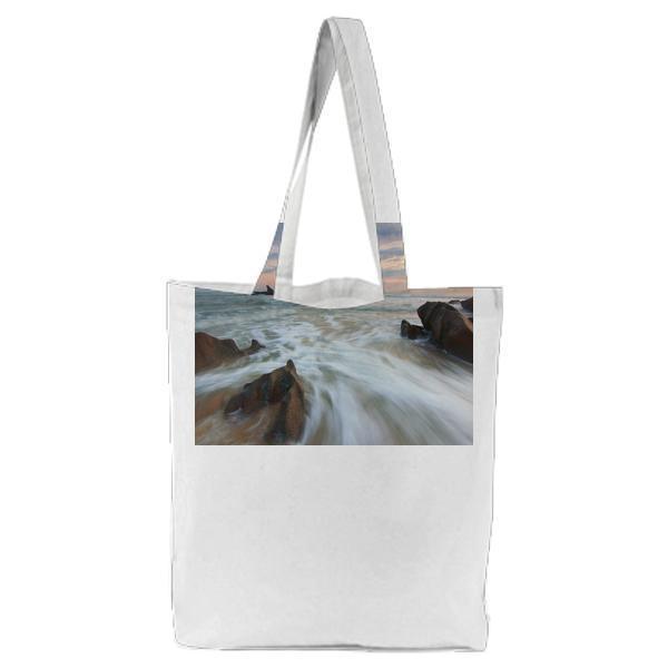 Brown Rocks Near A Body Of Water During Daytime Tote Bag