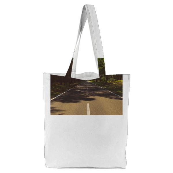 Photo Of Gray Cement Road In The Middle Forest During Day Time Tote Bag