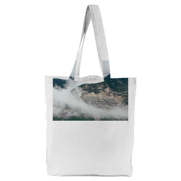 Green And Brown Mountains Covered Of Clouds During Daytime Tote Bag