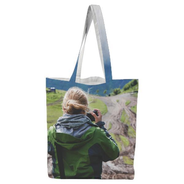 Woman In Green And Black Jacket Taking Photos Of The View During Daytime Tote Bag