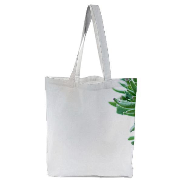 CloseUp Of Fresh Green Plant Against Tree Tote Bag