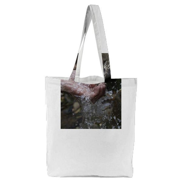 Person Cleaning Hands Under Water Tote Bag
