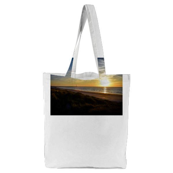 Sea Shore Beside Body Of Water During Sunset Tote Bag