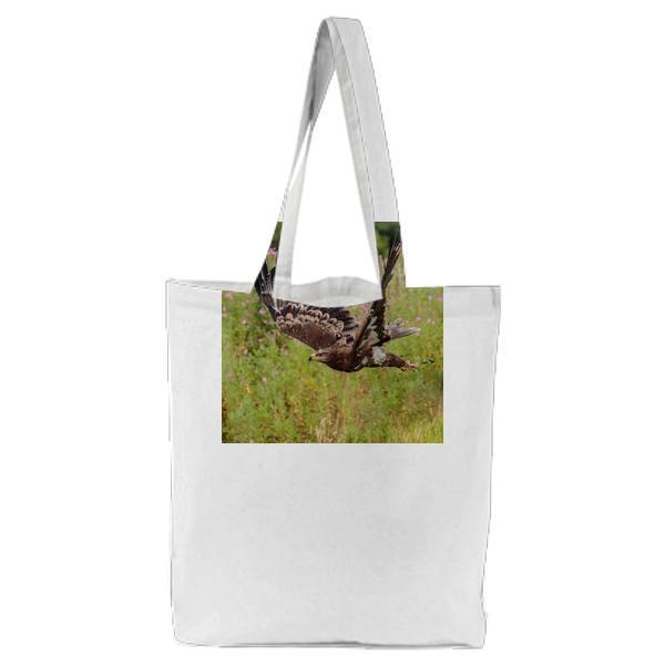 Brown White And Black Eagle Flying Nearby Pink Flower Field Tote Bag