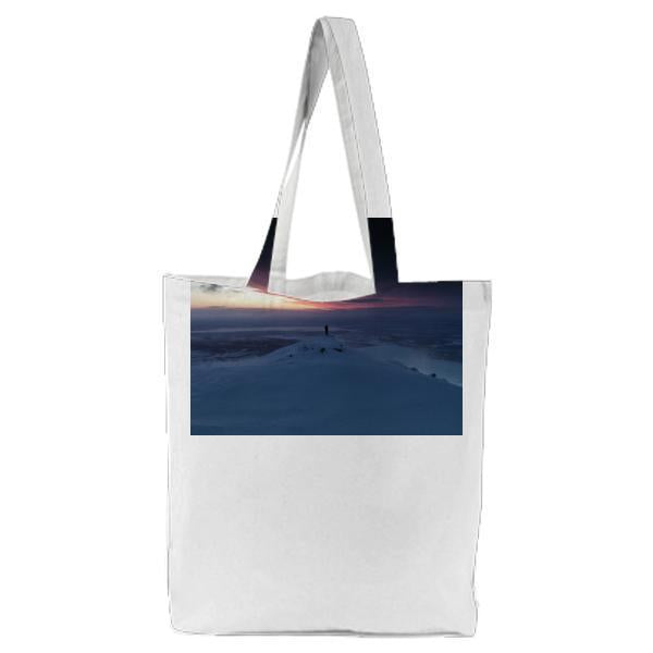 Person Standing On Snowy Cliff Near Sea Ocean During Night Time Tote Bag