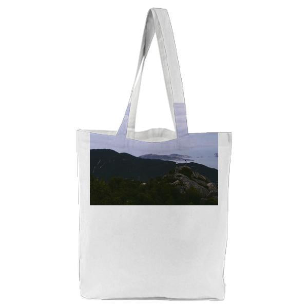Tow People Standing On A Cliff Over Body Of Water During Daytime Tote Bag