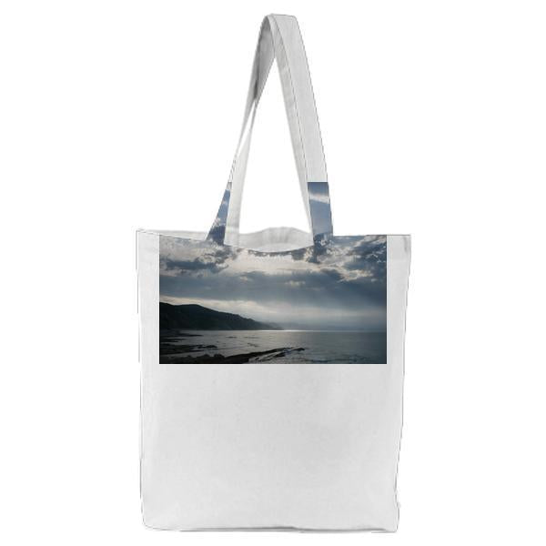 Blue Calm Water Near Mountain During Daytime Tote Bag