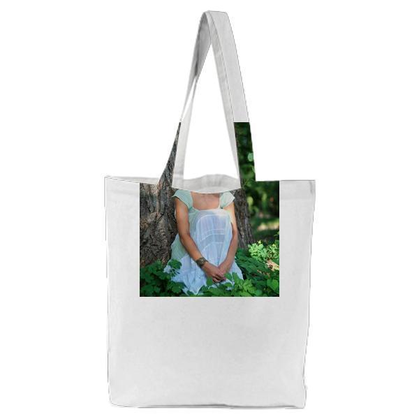Smiling Woman Wearing Green Leaf Crown With And White Sleeveless Dress Sitting In During Day Time Tote Bag
