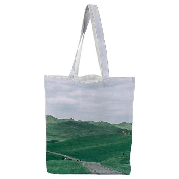 Green Grass Near Straight Road Under White Clouds And Blue Sky During Daytime Tote Bag