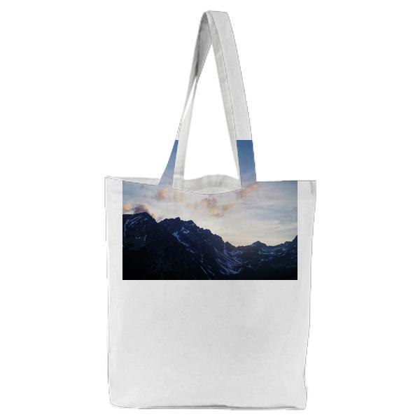 Black Mountain With White Snow Under Blue Sky Tote Bag