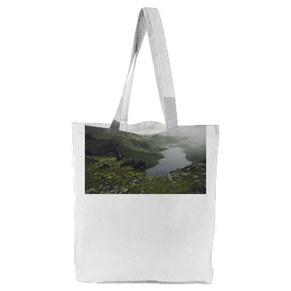 Green And Brown Mountain Near Lake During Foggy Day Tote Bag