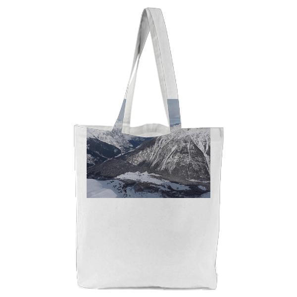 Snow Capped Mountain In Distance Under White Clouds During Daytime Tote Bag