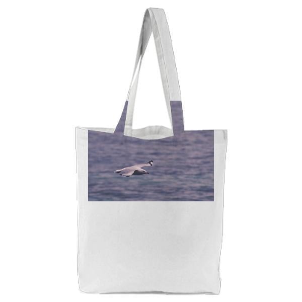 Seagull Flying Across Body Of Water Tote Bag