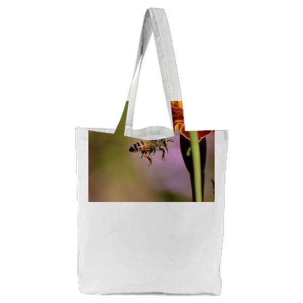 Honey Bee On Red And Yellow Flower During Daytime Tote Bag