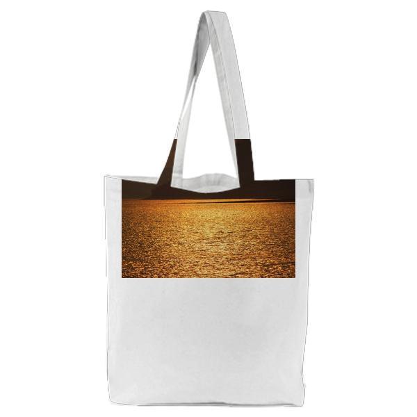 Blue Sea Near Brown Mountain During Sunset Tote Bag