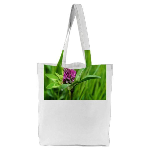 Purple Petal Flower On Green Grass Tote Bag