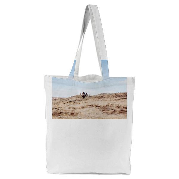 People Walking On Brown Hill During Daytime Tote Bag