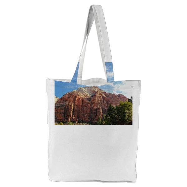 Photo Of Green Leaf Trees Beside Brown Mountains During Daytime Tote Bag