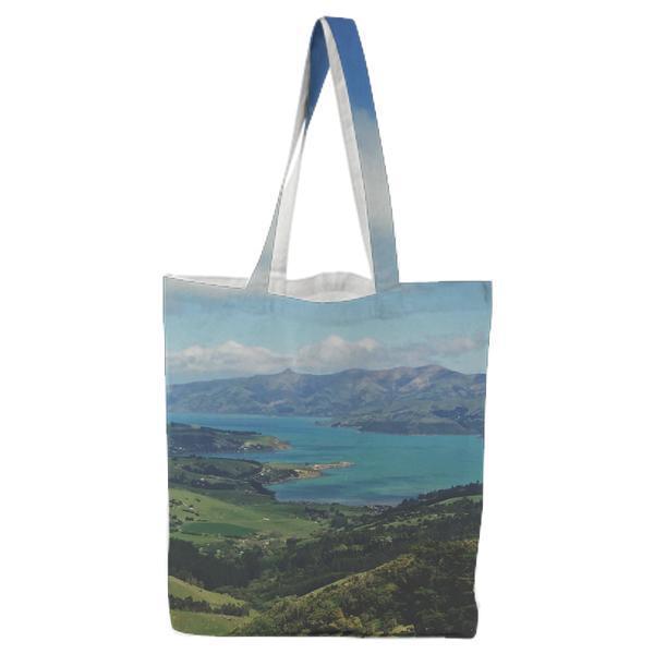 Green Trees In Mountains Beside Body Of Water Under Cloudy Skies During Daytime Tote Bag