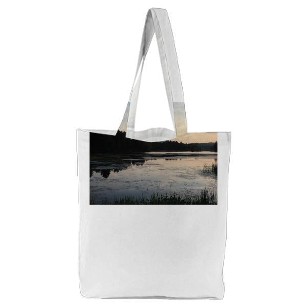 Body Of Water Surrounded By Green Trees During Sunset Tote Bag