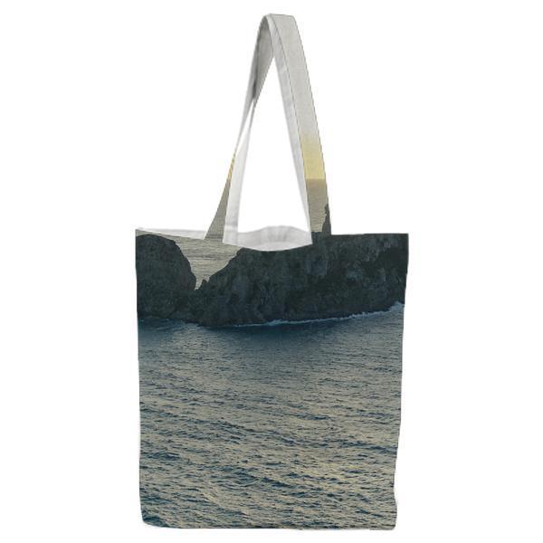 Grey And Brown Rock Island On Body Of Water During Daytime Tote Bag