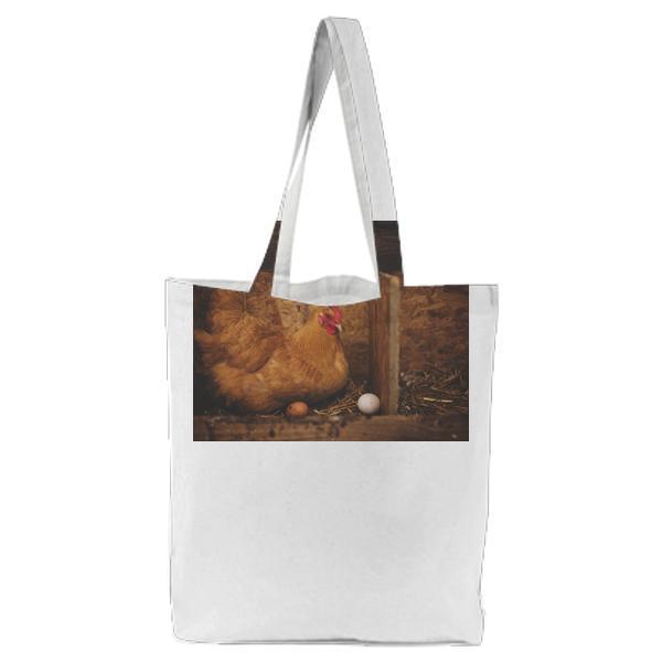 Brown Hen Near White Egg On Nest Tote Bag