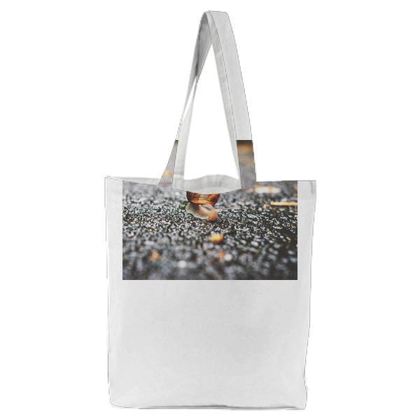 Selective Focus Photography Of Snail On Grey Asphalt Road During Daytime Tote Bag