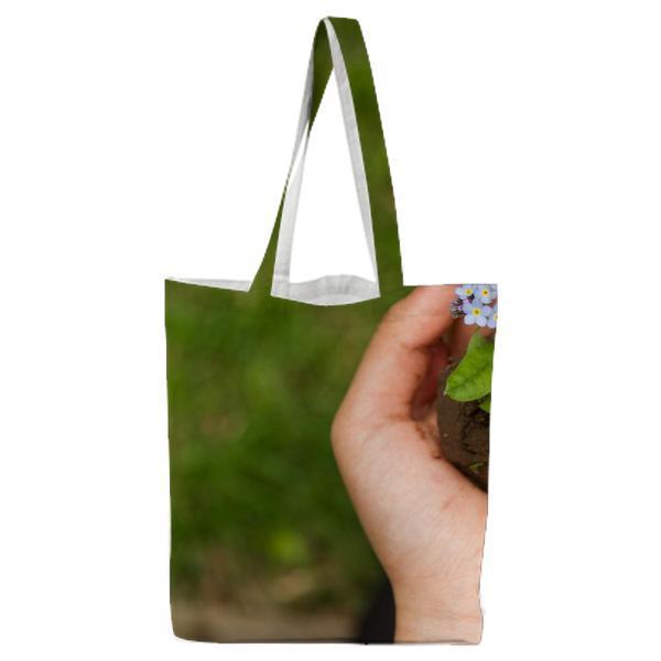 Person Holding White Flower Plant Tote Bag