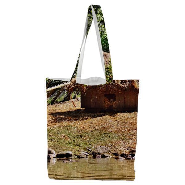 Brown Huts Beside Green Trees During Daytime Tote Bag