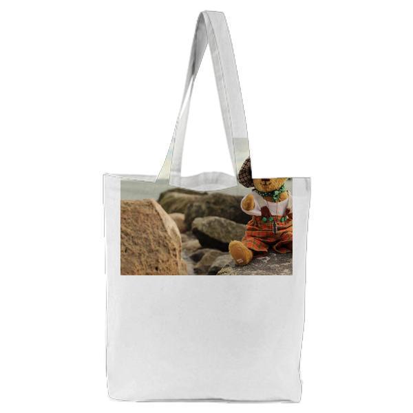 Toy On Rock By Sea Against Sky Tote Bag