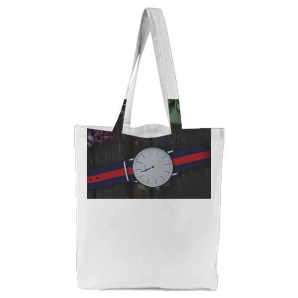Blue And Red Strap Silver Round Analog Watch Beside Purple Green Leaf Plant Tote Bag