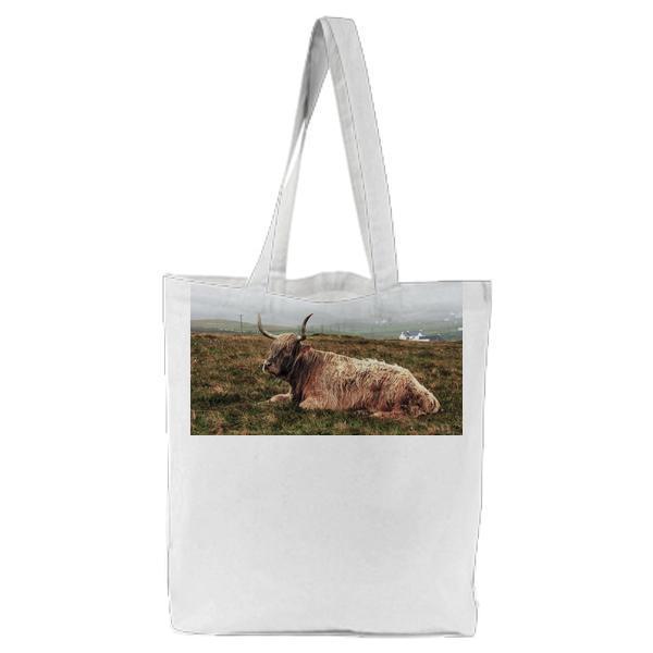 Grey Buffalo Lying On Green Grass During Daytime Tote Bag
