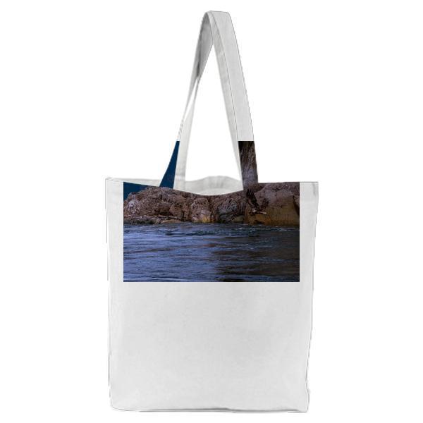 Black Fird Flying On Water During Daytime Tote Bag